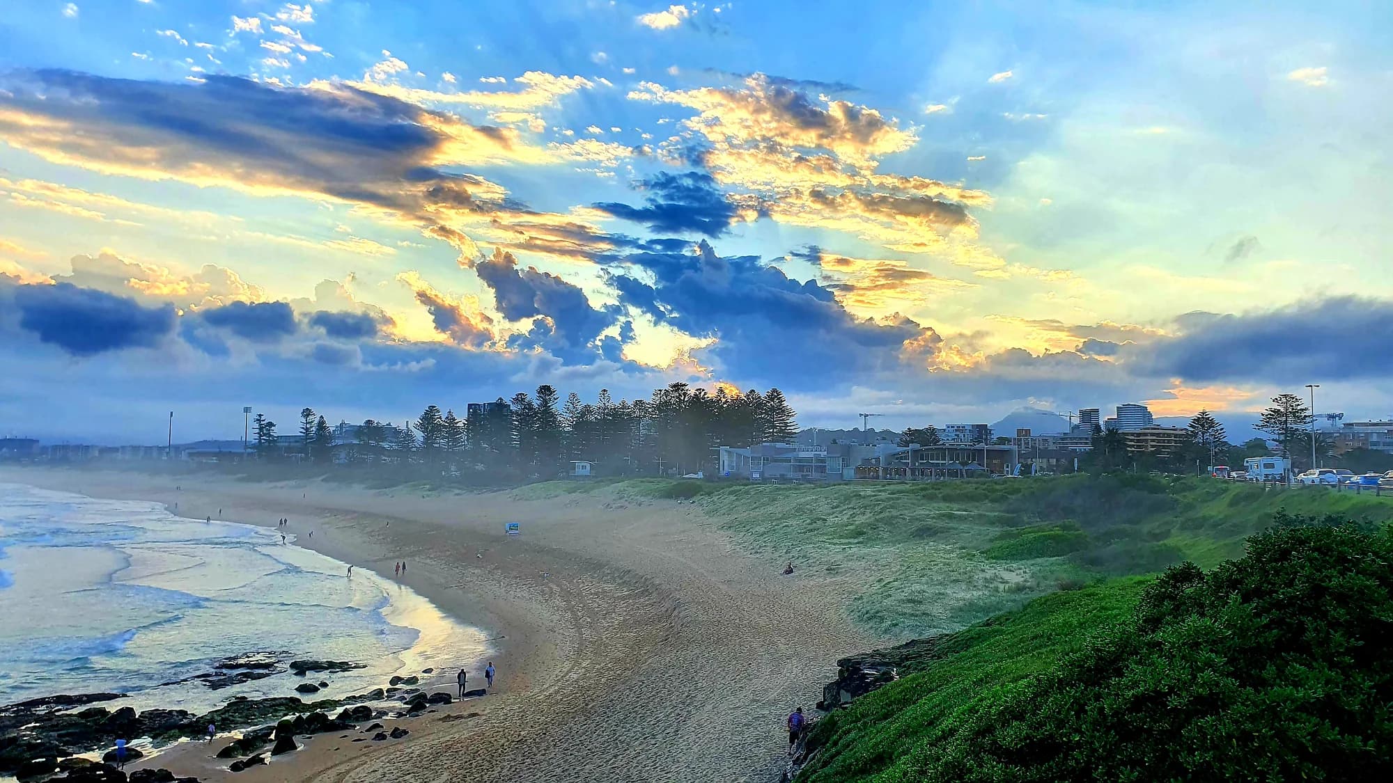 Morning light and scattered cloud over the curve of North Wollongong Beach