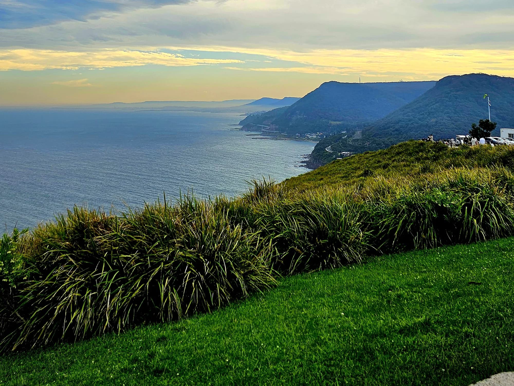 Evening sky over the ocean and headlands from the grassy slope of Bald Hill