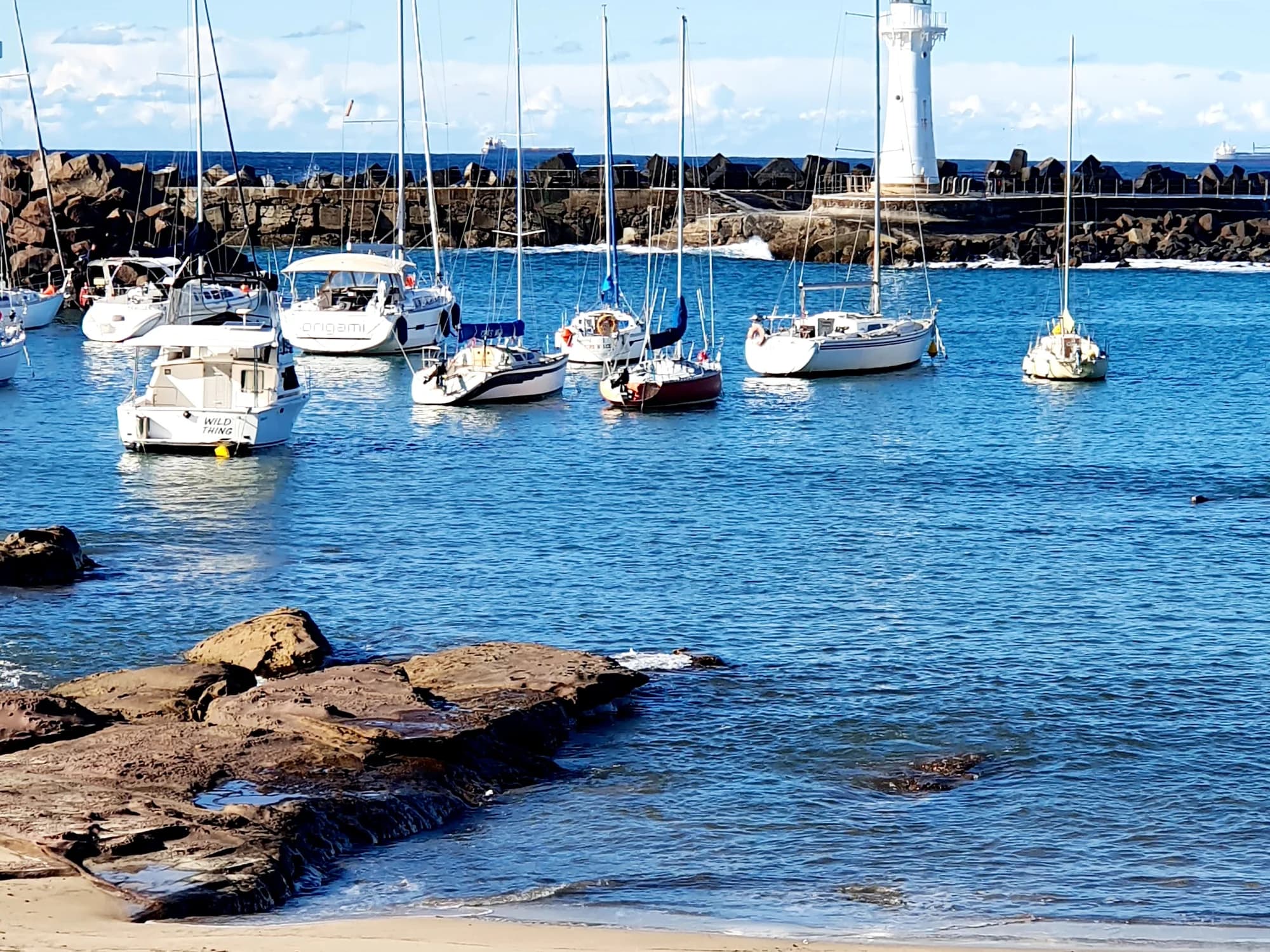 Boats moored in Wollongong Harbour below the Breakwater Lighthouse