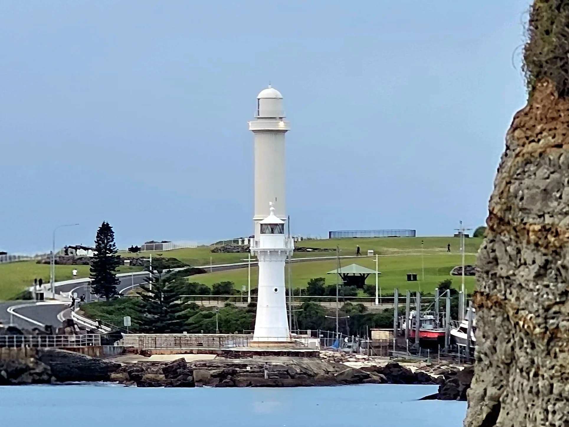 Flagstaff Point and Breakwater lighthouses seen together across the rock shelf from North Beach